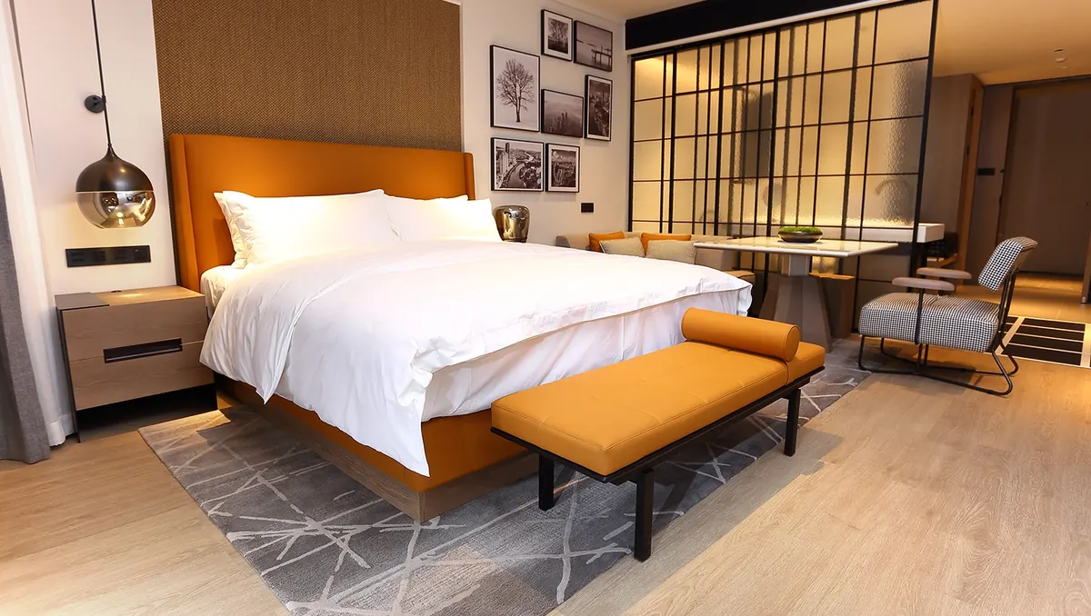 A finished hospitality bedroom with custom furniture