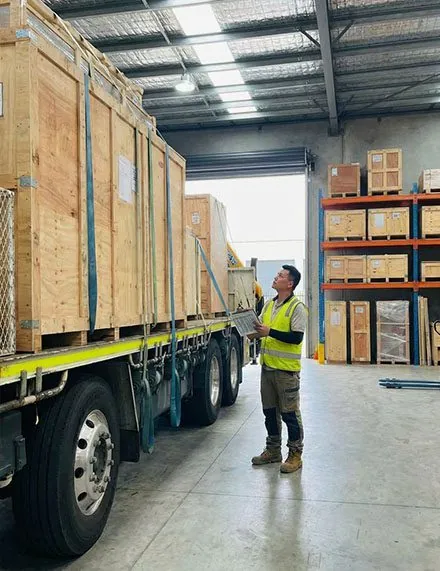 Crated goods on a truck being checked in a warehouse