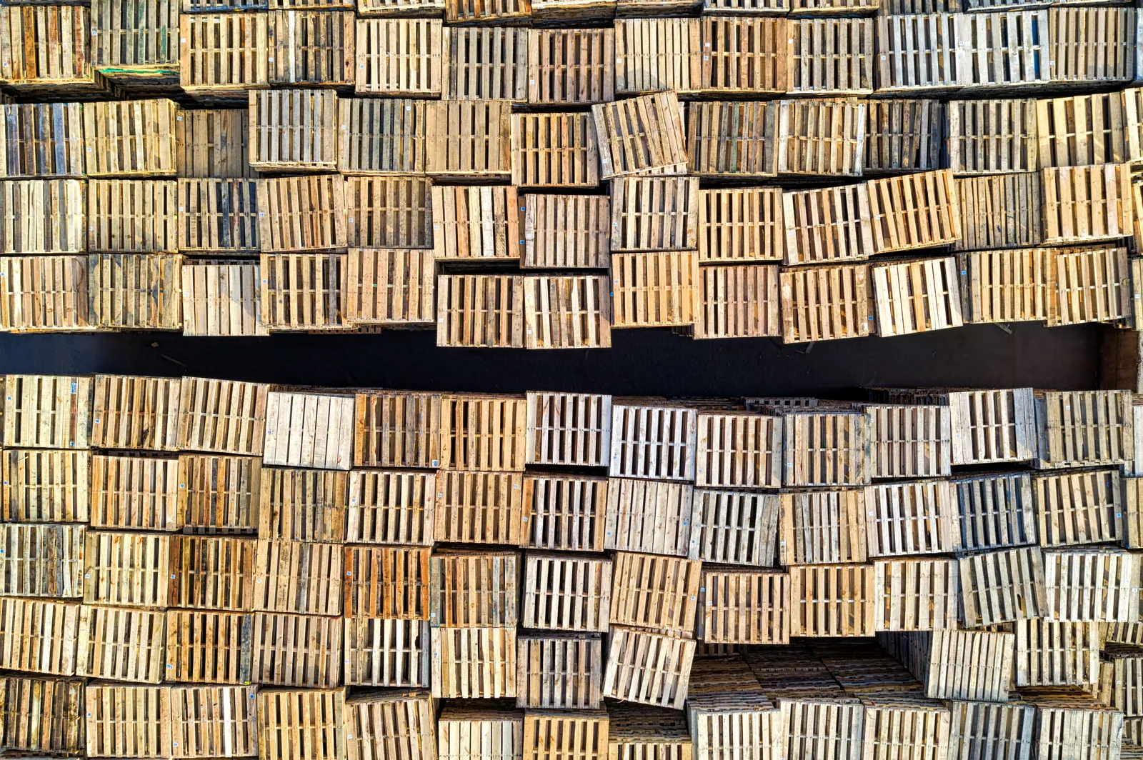 Timber pallets stacked outdoors in a storage yard