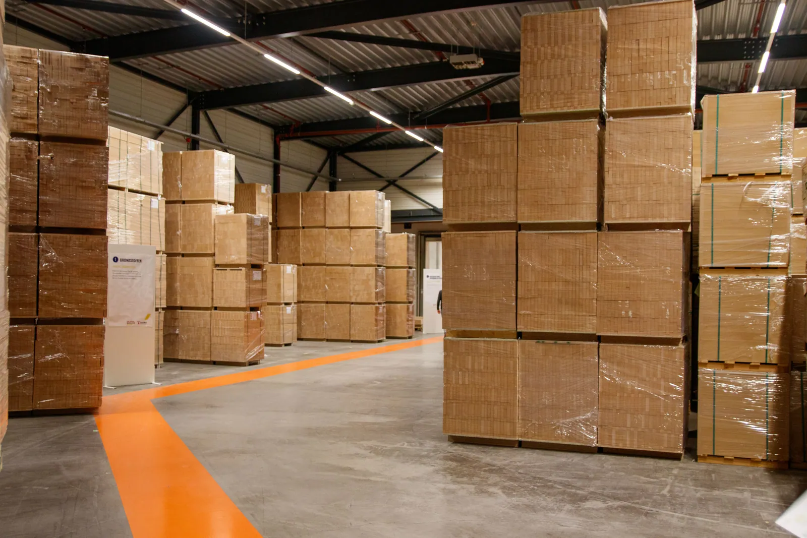 Palletized cardboard cartons stored inside an industrial warehouse