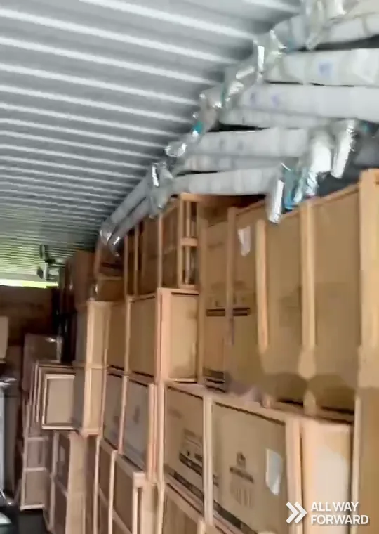 Crates and cartons stacked inside a container during loading