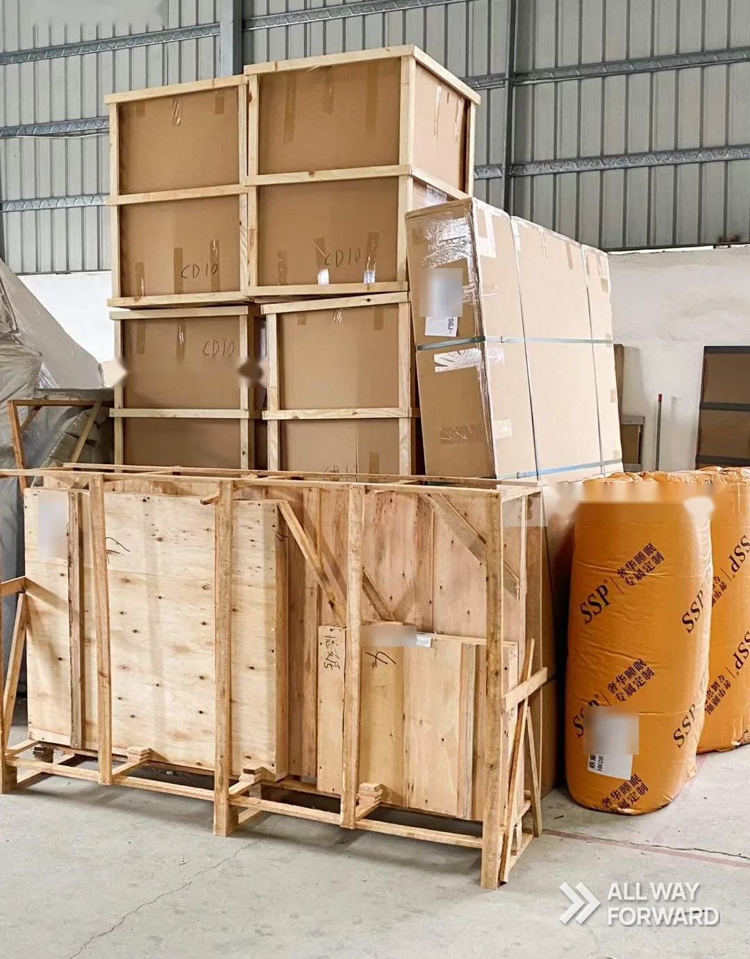 Wooden crates and wrapped furniture staged in a warehouse before loading