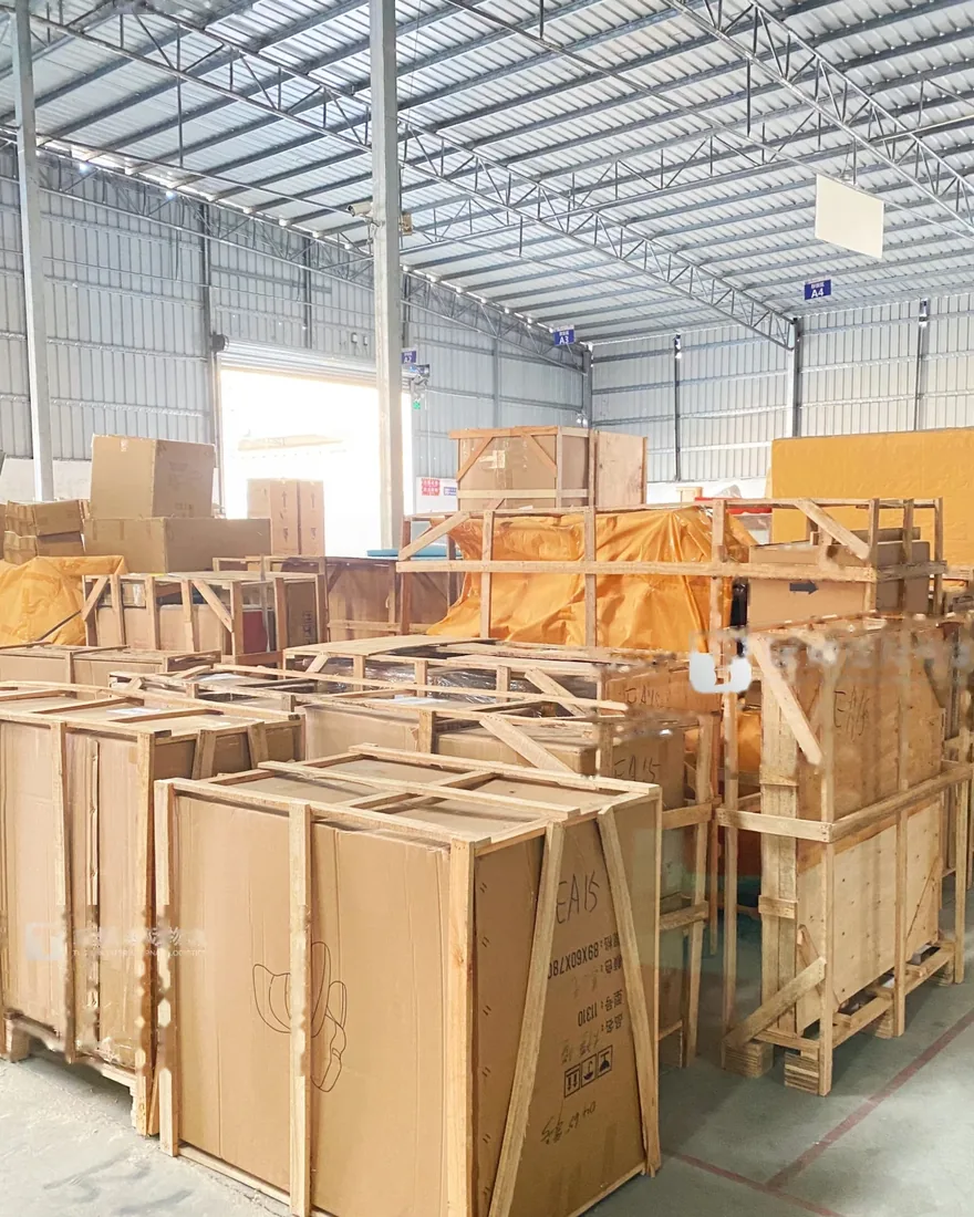 Crated furniture staged in a warehouse before loading