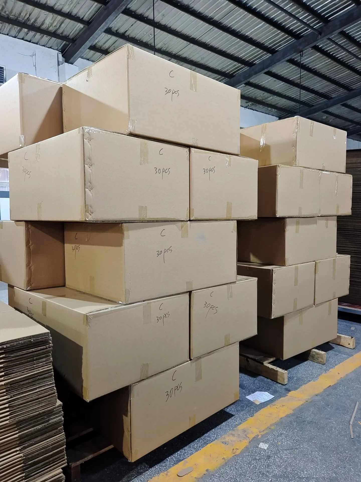 Cartons and wrapped pallets organized for warehouse receiving or dispatch.