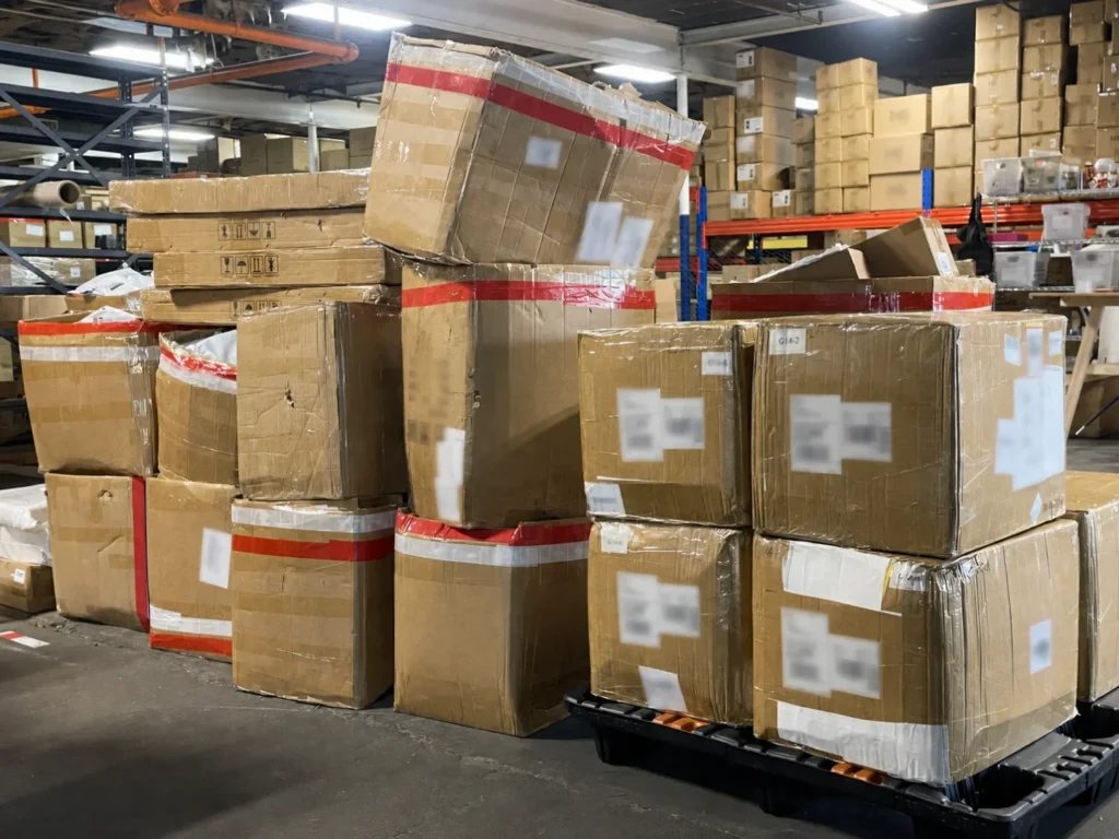 Cartons and wrapped pallets organized for warehouse receiving or dispatch.