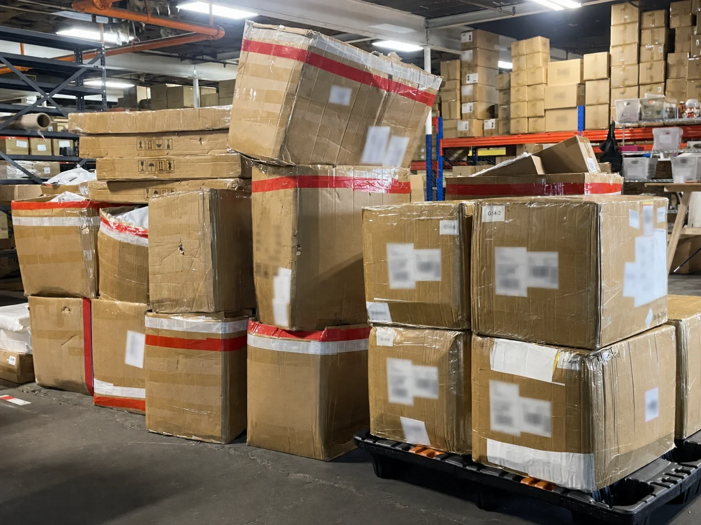 Cartons and wrapped pallets organized for warehouse receiving or dispatch.