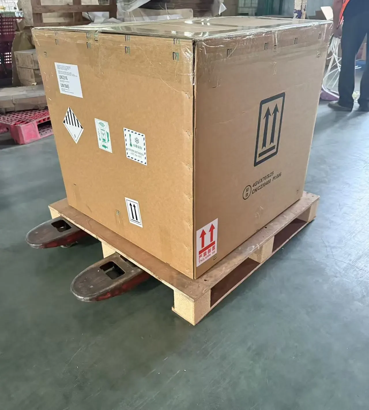 An outer cargo package with handling labels secured on a pallet.